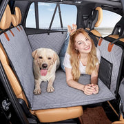 Gray hard-bottom dog backseat extender installed in a full-size truck