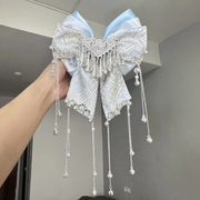 Blue DIY Hanfu-inspired brocade bow hair accessory with silver bells and tassels