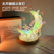 Completed DIY moon butterfly night light glowing with warm ambient light