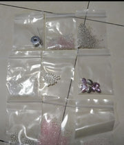 DIY beaded necklace kit components with beads pearls thread and needle