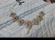 Pink beaded statement necklace finished example on fabric