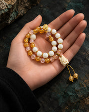 Golden Vigil double-wrap bracelet in an open palm